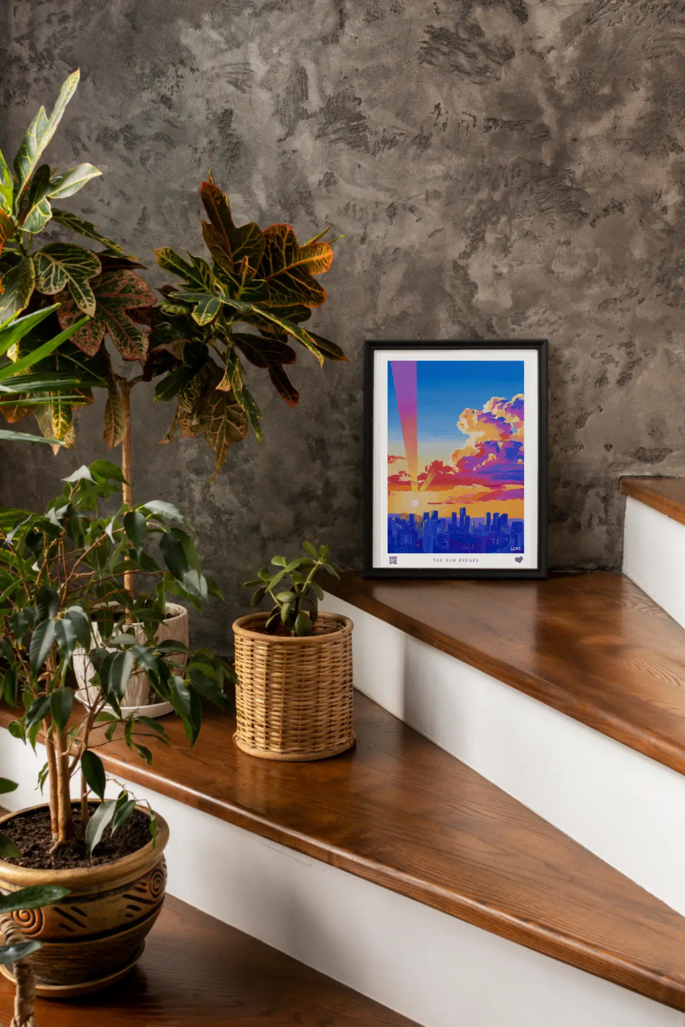 A framed wall art above a stylish chair. Below the artwork is a stylish QR code to the left, the piece name in the centre, and a stylish heart logo on the right.